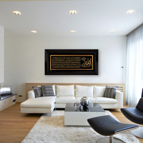 A living room with a white couch and a black framed picture Description automatically generated